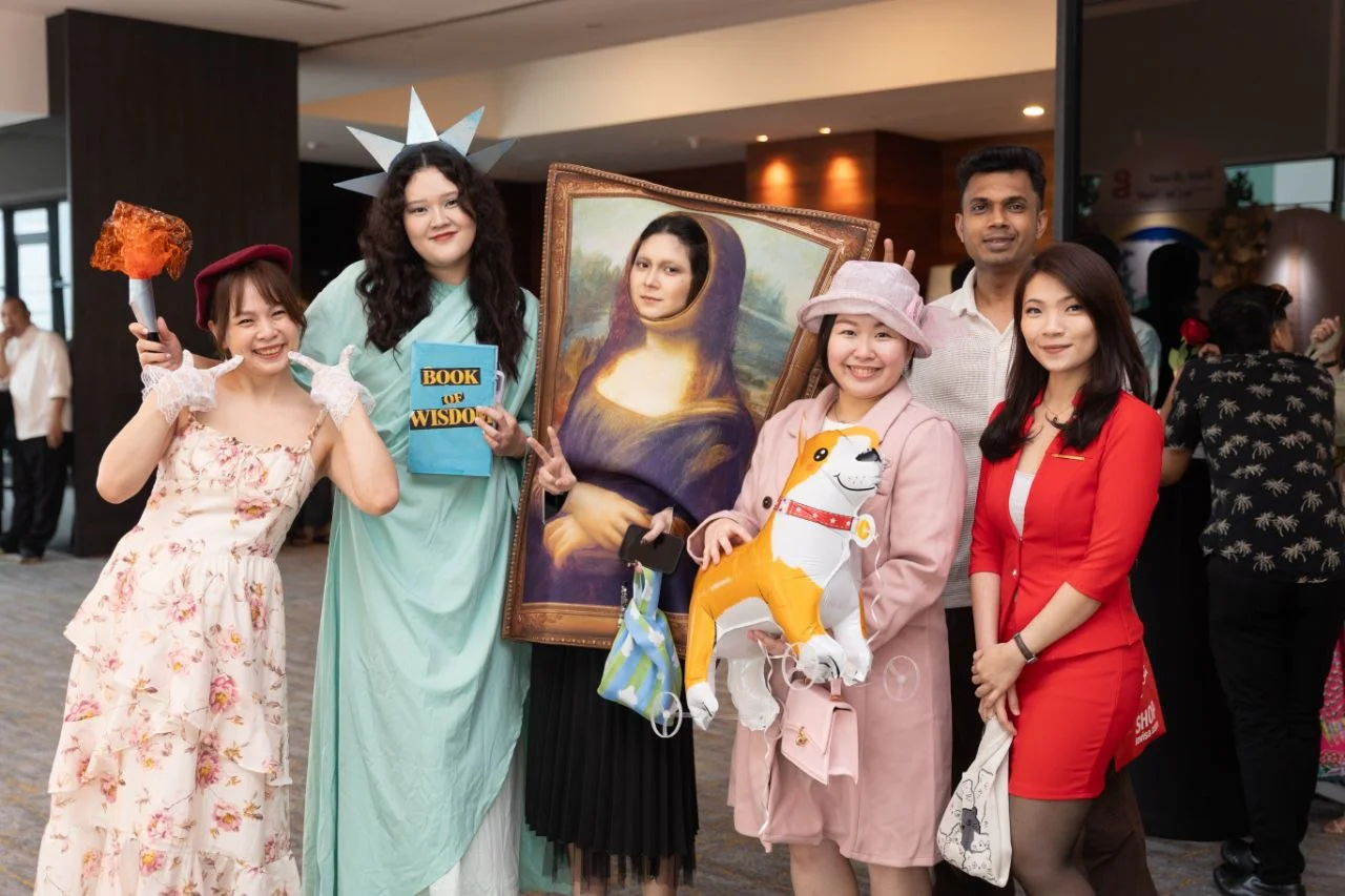 G Hotel associates pose with themed props at the Staff Party 2026
