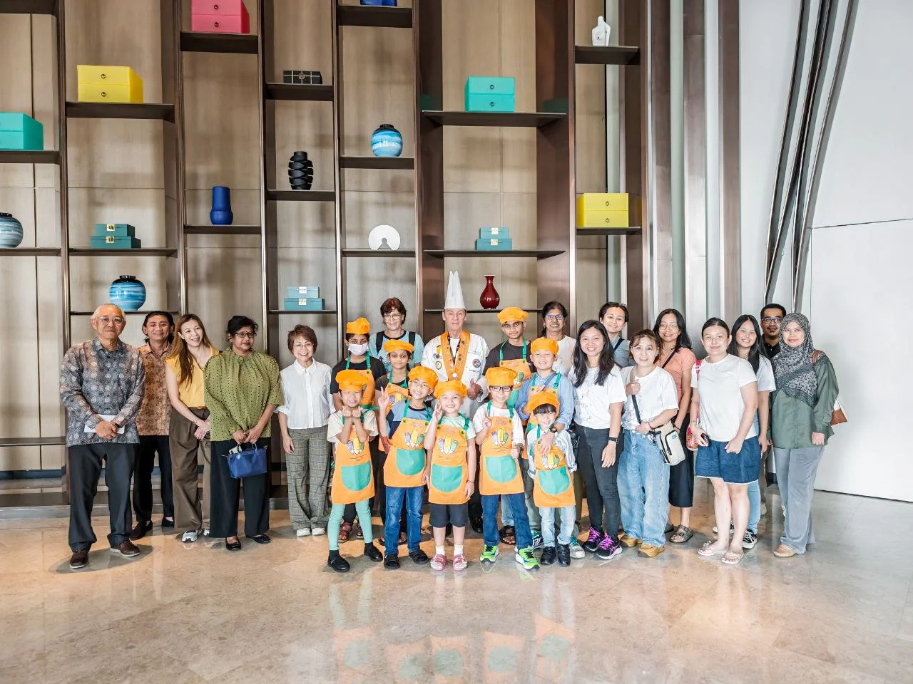 Children from the 2 Way Centre with a chef at a group photo session during the Battle of the Chefs.