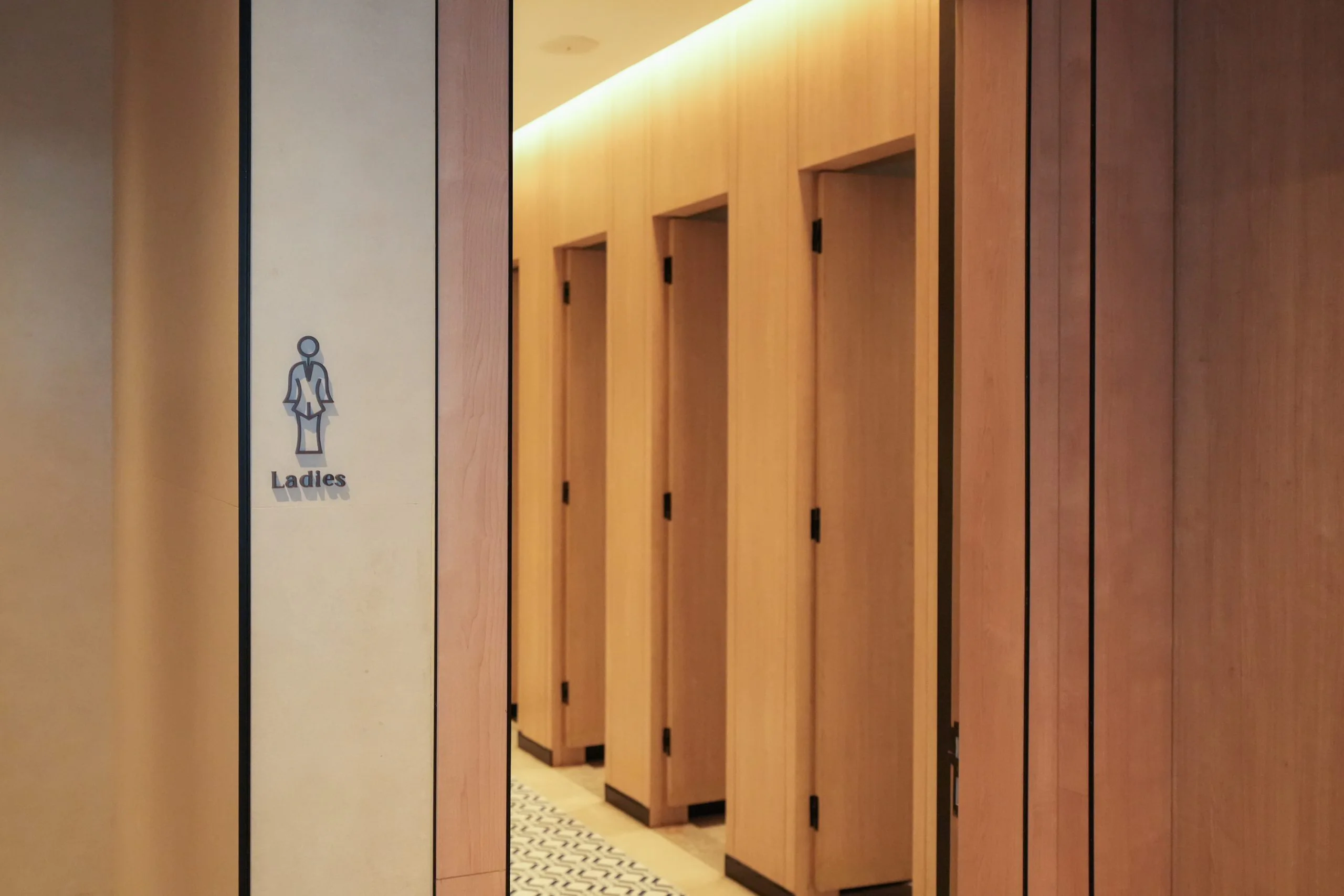 The Ladies washroom corridor at Iconic Marjorie Penang, lined with timber stall doors.
